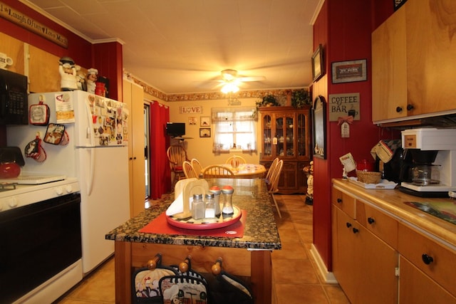 kitchen with light tile patterned floors, white range, a center island, and ceiling fan