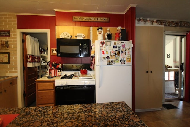 kitchen featuring white appliances, ornamental molding, and brick wall