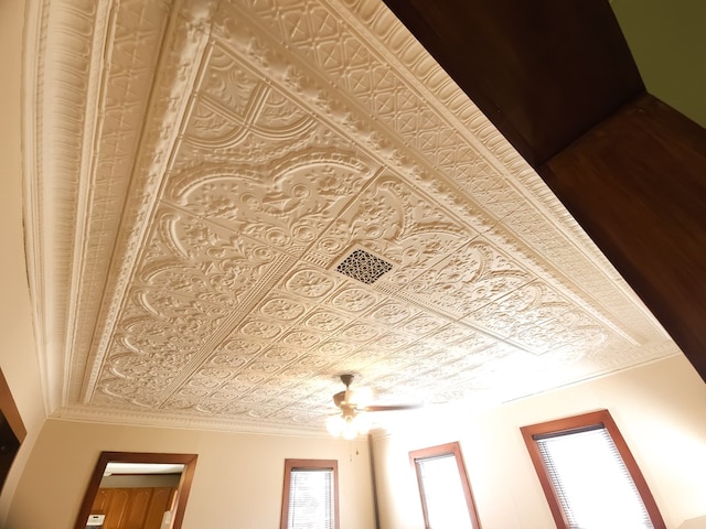 interior details featuring ceiling fan and crown molding