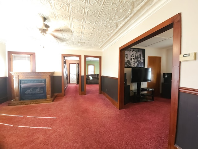 unfurnished living room featuring dark carpet and crown molding