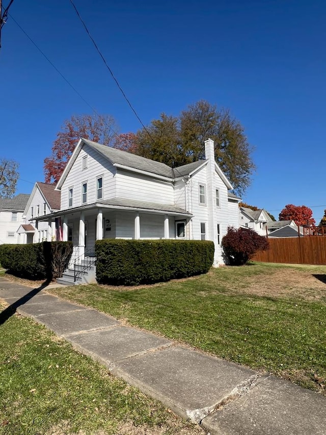 view of side of property featuring a yard