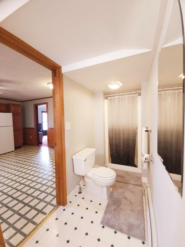 bathroom with a baseboard radiator and toilet