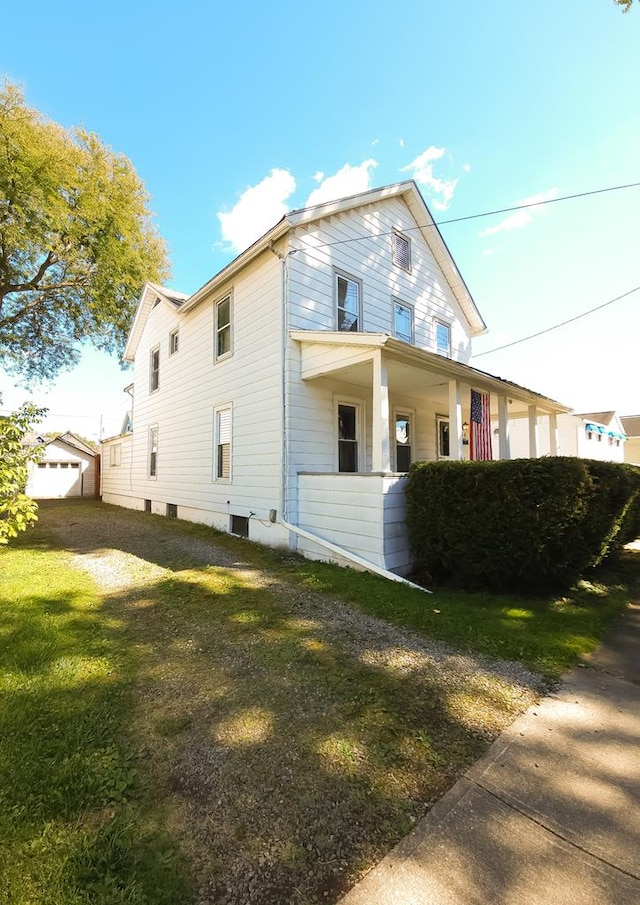 view of side of property with a lawn and a porch