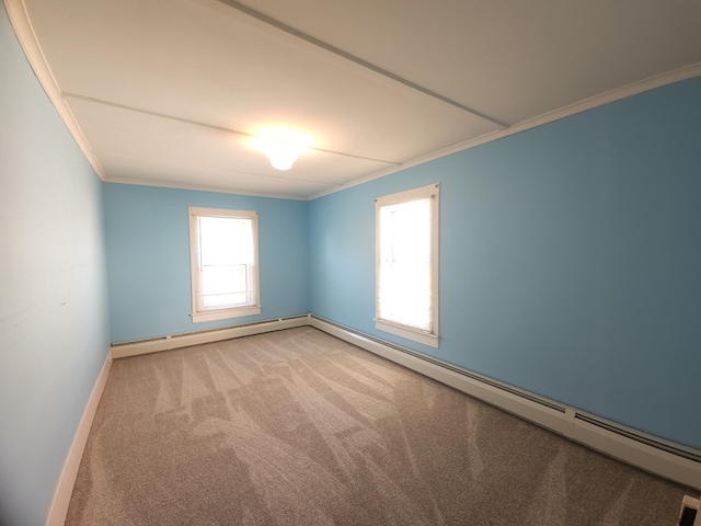 carpeted empty room with baseboard heating and crown molding