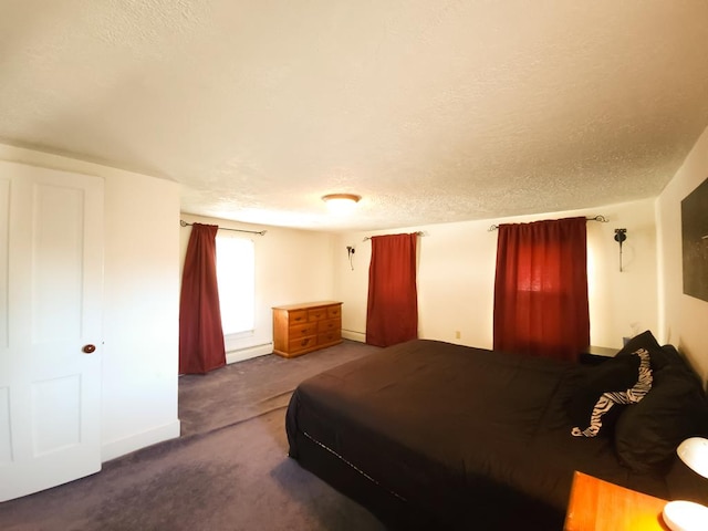 bedroom featuring carpet and a textured ceiling