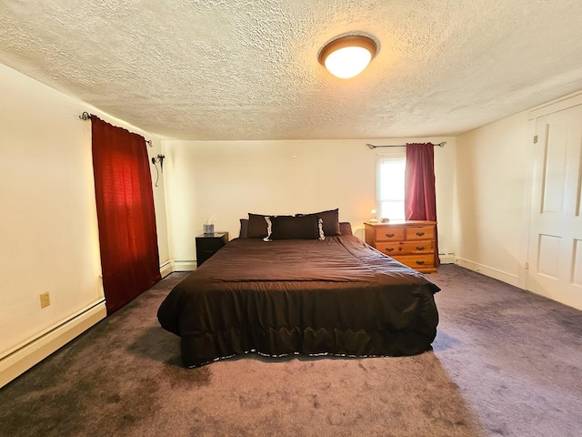 bedroom featuring dark colored carpet, a textured ceiling, and a baseboard radiator