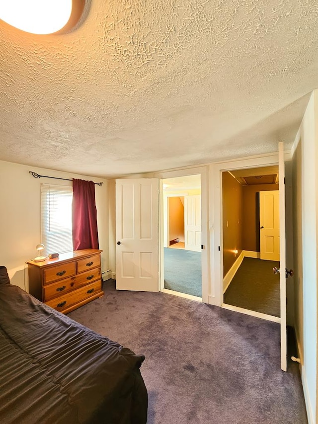 carpeted bedroom with a textured ceiling and a baseboard heating unit