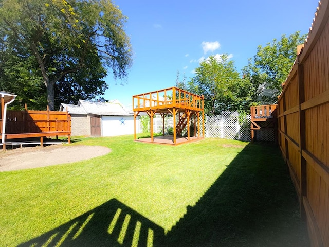 view of yard featuring a shed and a deck