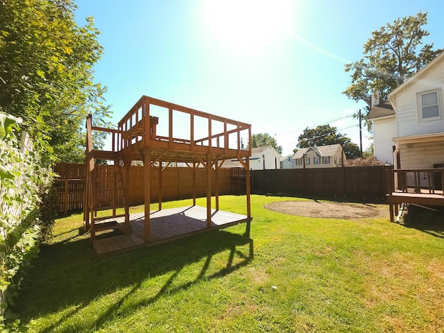 view of yard with a wooden deck and a patio