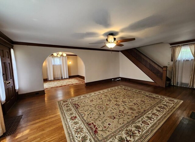 interior space featuring dark wood-type flooring and ceiling fan