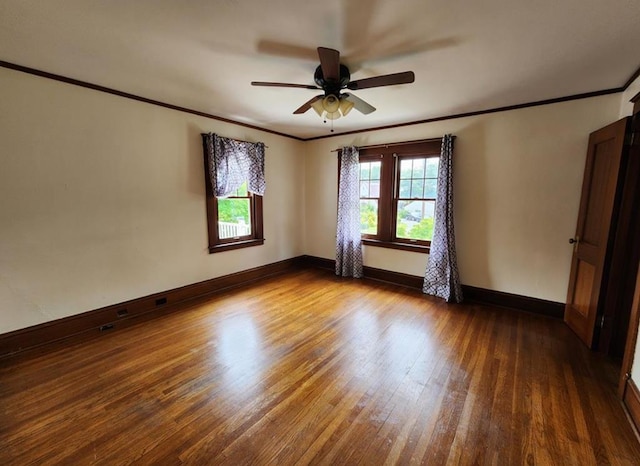 empty room featuring hardwood / wood-style flooring, ornamental molding, and ceiling fan