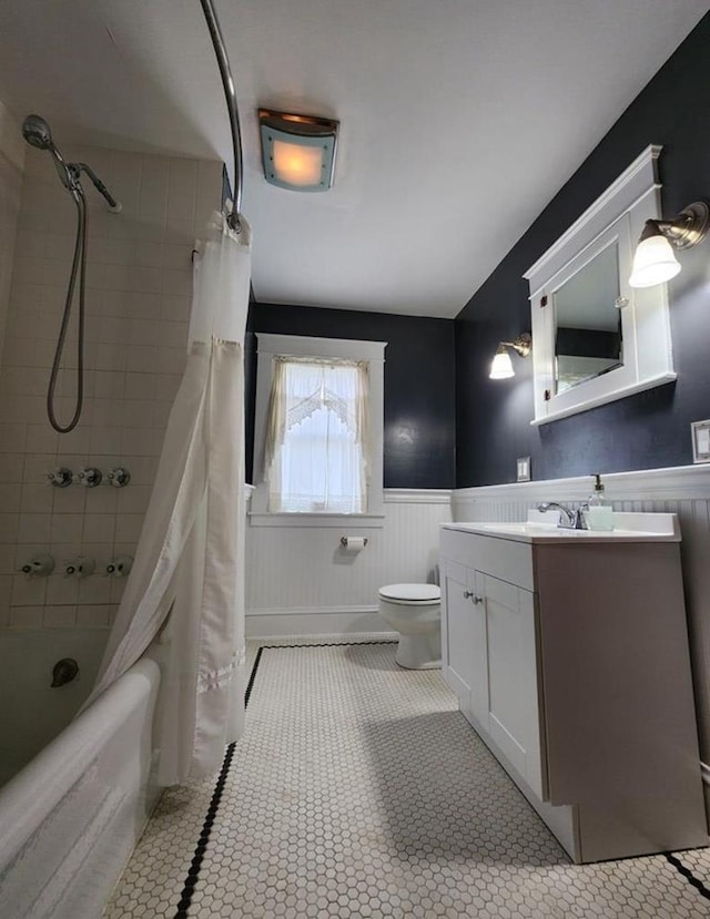 full bathroom with tile patterned flooring, vanity, shower / bath combo, and toilet