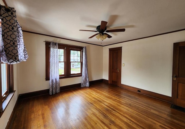 unfurnished room with wood-type flooring, ceiling fan, and crown molding