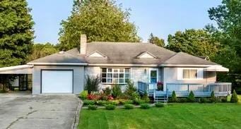 view of front facade featuring a front yard and a carport