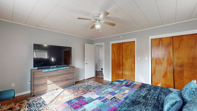 bedroom featuring hardwood / wood-style flooring, ceiling fan, and ornamental molding