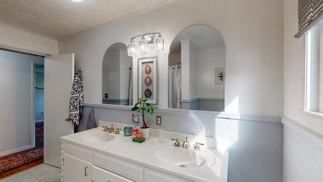 bathroom with vanity, a textured ceiling, and hardwood / wood-style flooring