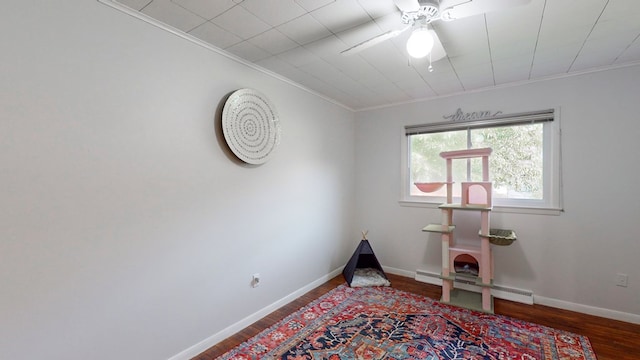 misc room with baseboard heating, crown molding, ceiling fan, and wood-type flooring