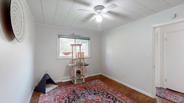 interior space with ceiling fan, dark hardwood / wood-style floors, and ornamental molding