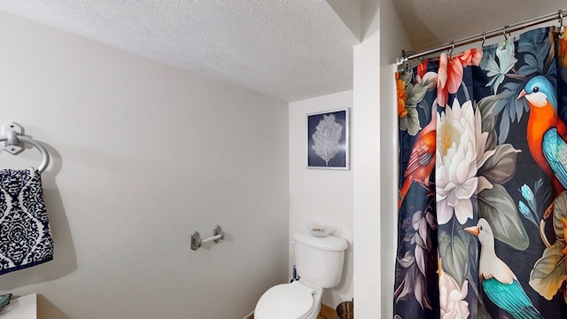 bathroom with a textured ceiling and toilet