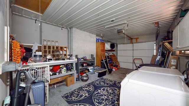 garage with washing machine and dryer and a garage door opener