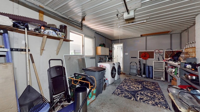 garage featuring independent washer and dryer and a garage door opener