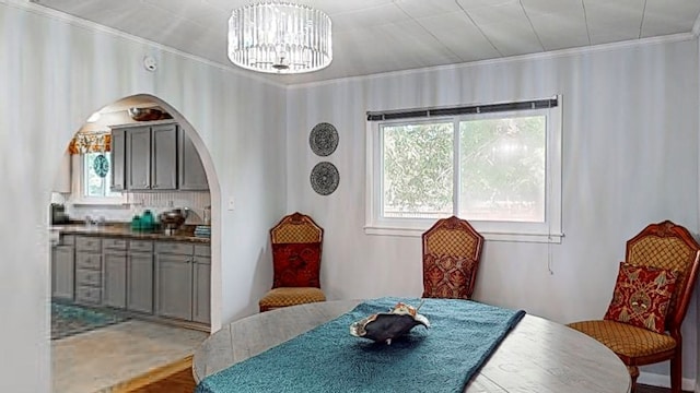 dining space with a chandelier and crown molding