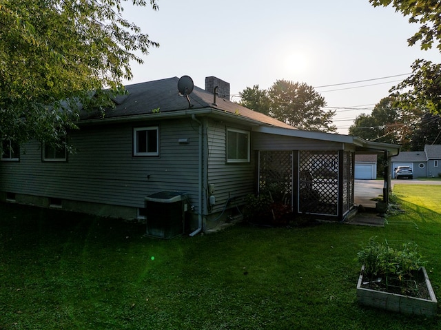 view of side of home with a yard and cooling unit