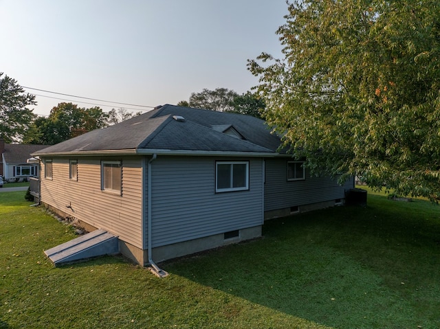 view of property exterior featuring a lawn