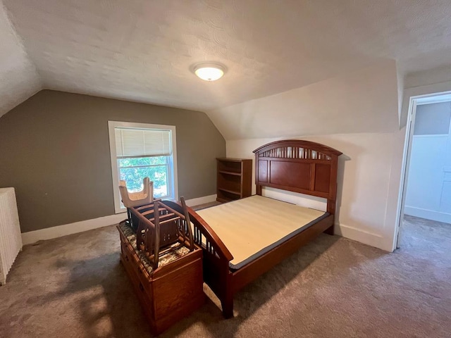 carpeted bedroom with lofted ceiling, a textured ceiling, and radiator heating unit