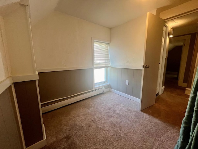 carpeted spare room featuring a baseboard radiator