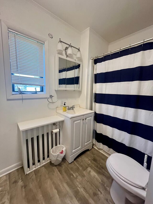 bathroom with hardwood / wood-style flooring, toilet, ornamental molding, vanity, and curtained shower