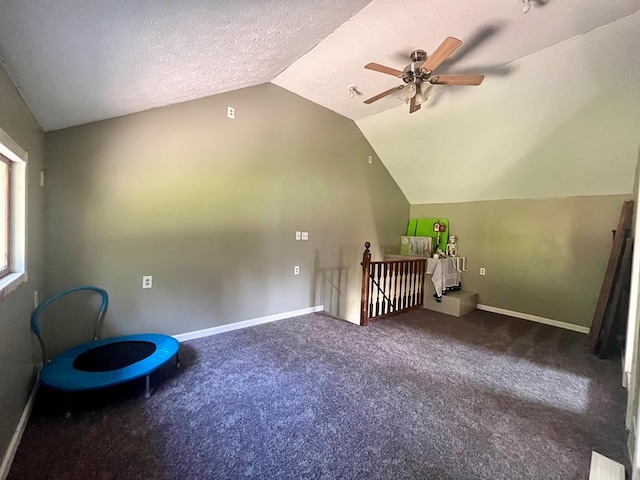 bonus room featuring ceiling fan, carpet, lofted ceiling, and a textured ceiling