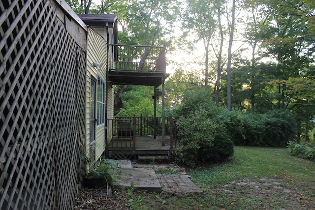 view of yard with a balcony and a wooden deck