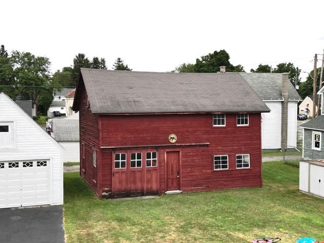 exterior space with a garage and a yard