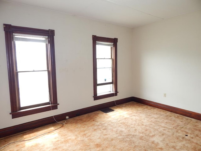 unfurnished room with light colored carpet