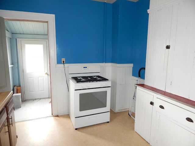 kitchen featuring white cabinetry and white range oven