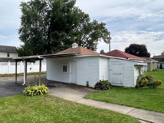 view of outbuilding with a yard