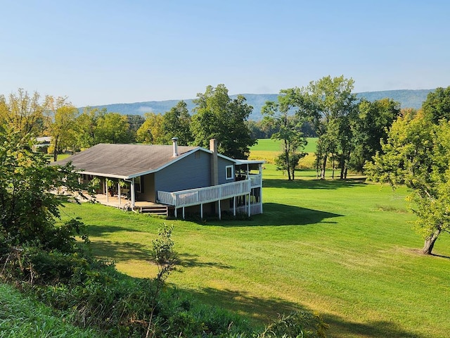 exterior space with a wooden deck and a rural view