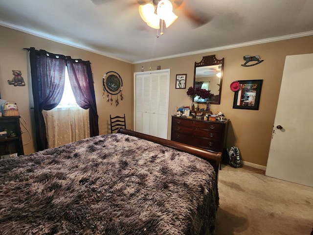 bedroom featuring ceiling fan, a closet, crown molding, and light carpet