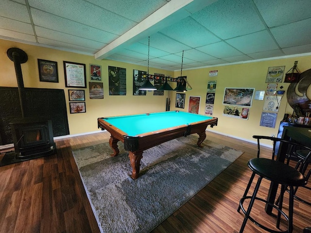 game room featuring wood-type flooring, a wood stove, beam ceiling, a paneled ceiling, and billiards