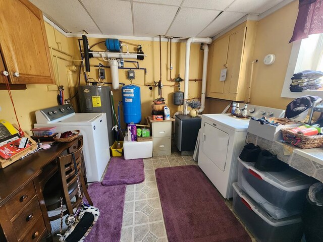 washroom with water heater, separate washer and dryer, and light tile patterned floors