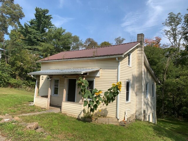 back of house with a lawn