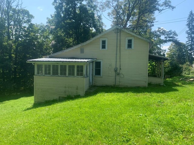 rear view of house with a lawn