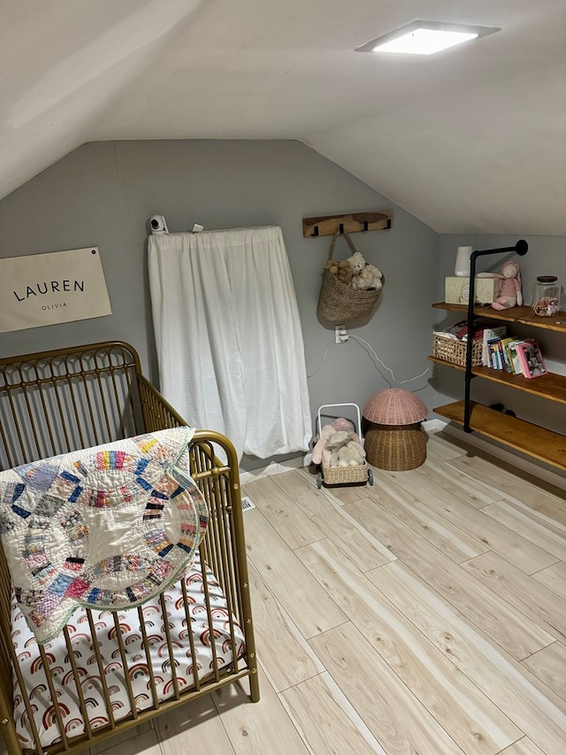 bedroom with wood-type flooring and lofted ceiling