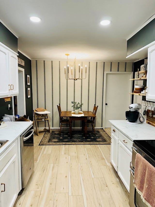 kitchen with light stone countertops, pendant lighting, white cabinets, and stainless steel appliances