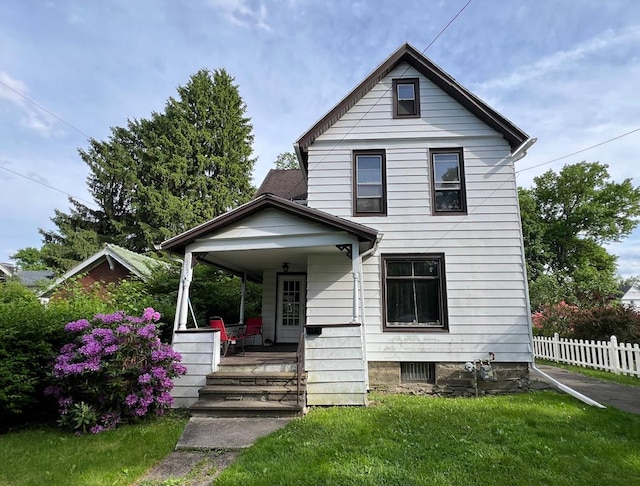 view of front of house featuring a front yard and covered porch