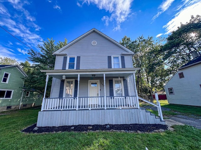 view of front facade with a front lawn and a porch