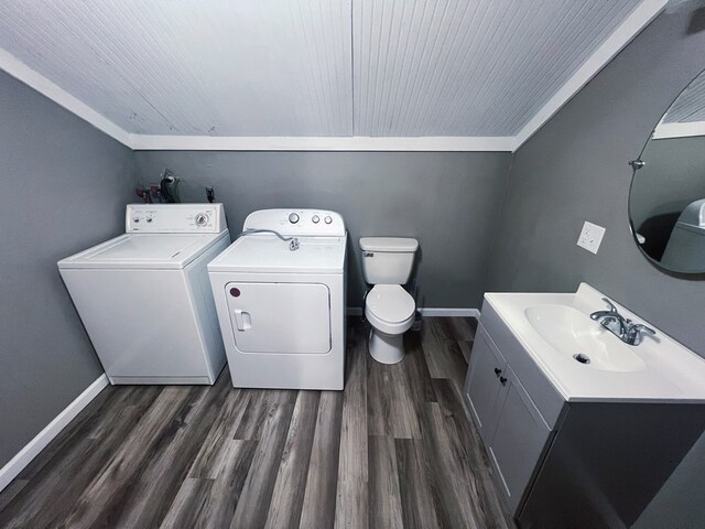 bathroom with separate washer and dryer, hardwood / wood-style floors, vanity, toilet, and ornamental molding