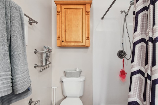 bathroom featuring toilet and walk in shower