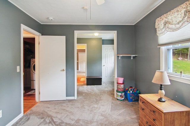 game room featuring washer / dryer, light carpet, and ornamental molding